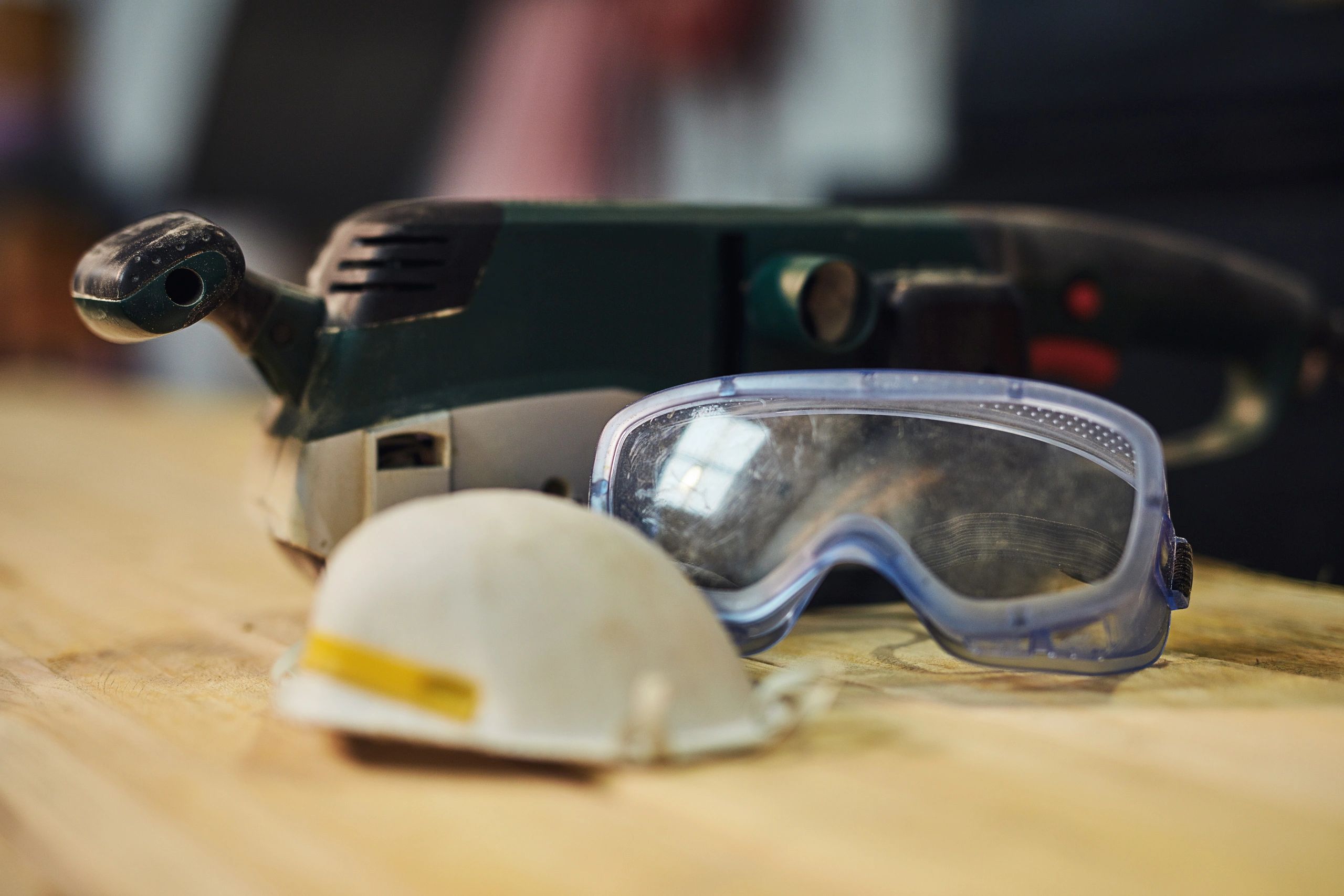 Personal protective equipment and safety gear arranged on a work surface