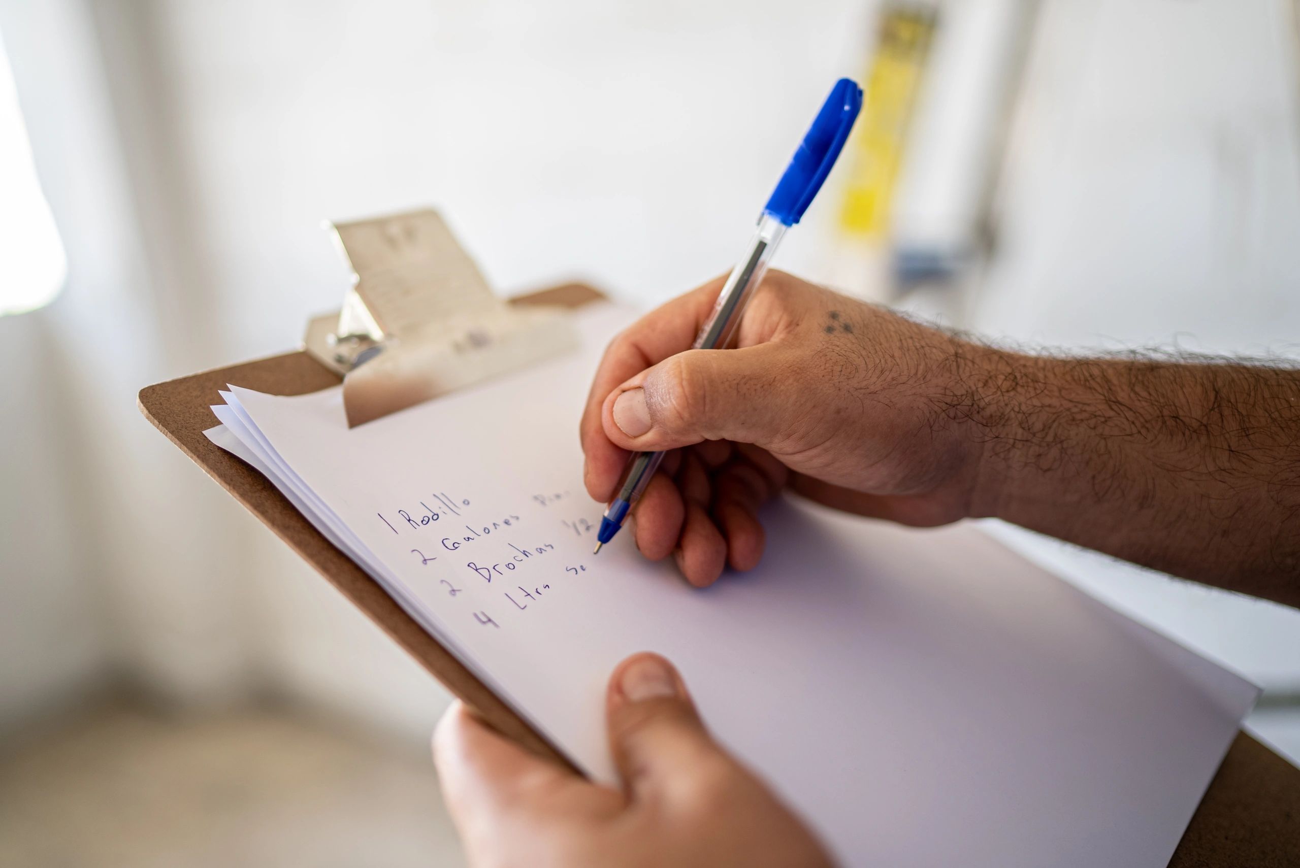 Inspector writing notes on a clipboard during a construction quality check
