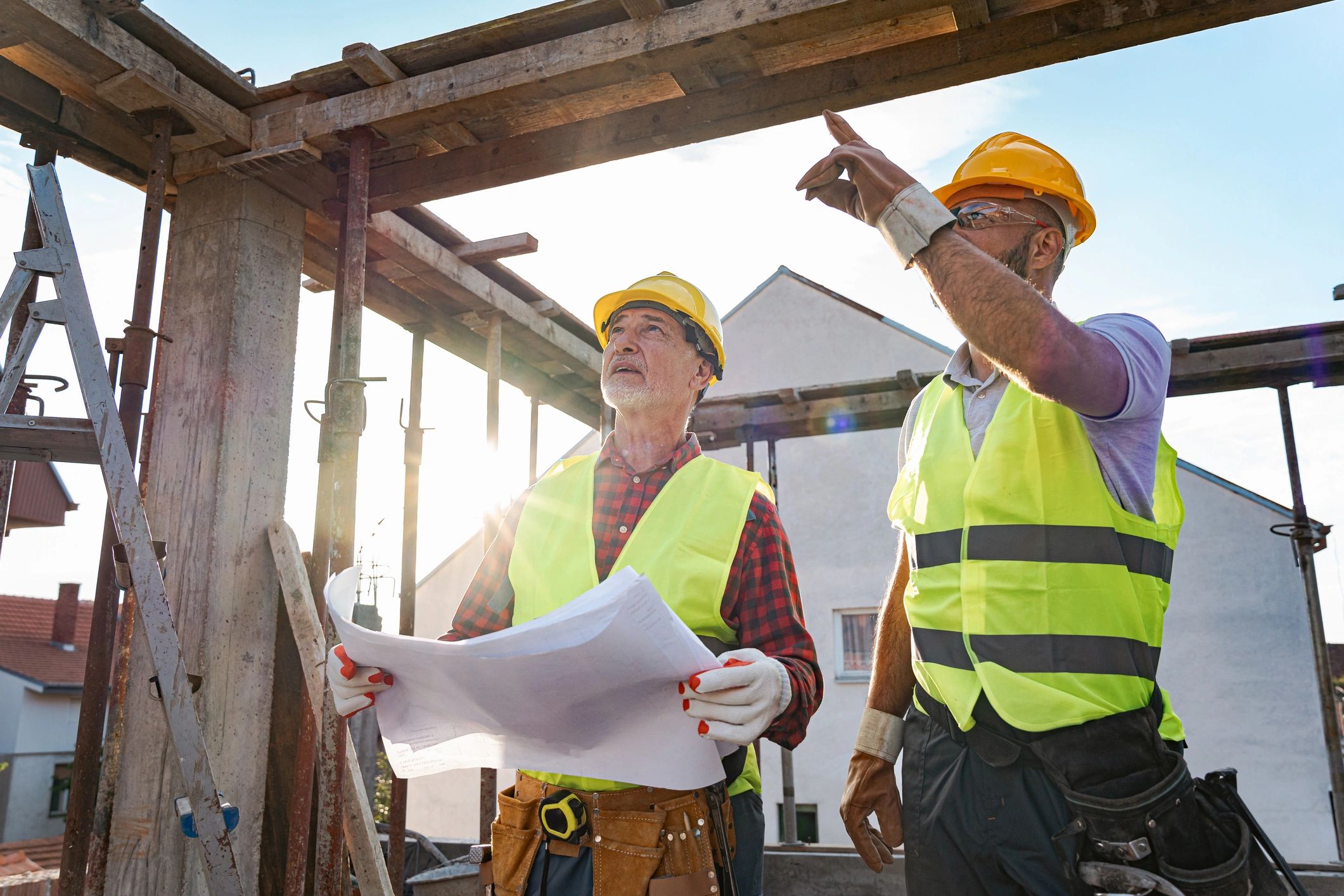 Engineer and contractor reviewing plans on a construction site