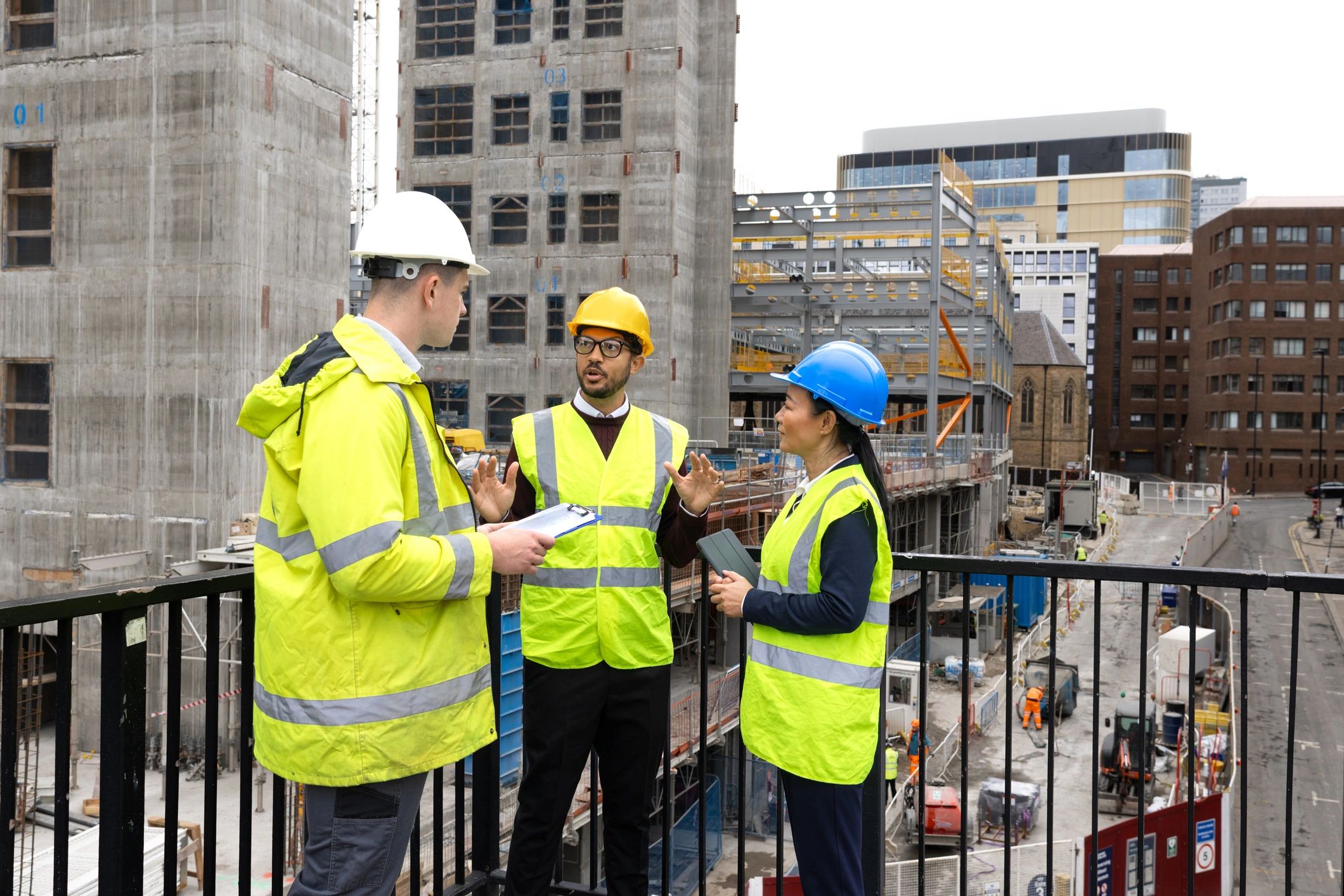 Construction team meeting at a site office reviewing plans